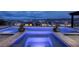 Stunning infinity pool with integrated spa, lush planters, and panoramic city and mountain views at 148 Tre Pietre St, Henderson, NV 89011