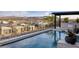 Outdoor pool and patio area with mountain views and outdoor kitchen at 148 Tre Pietre St, Henderson, NV 89011