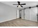 Bedroom showcasing a ceiling fan, barn doors, and wood-look flooring at 1906 Palora Ave, Las Vegas, NV 89169