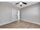 Bedroom with wood floors, ceiling fan and white doors at 1906 Palora Ave, Las Vegas, NV 89169