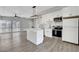Modern kitchen features stainless appliances, island, sleek countertops, and ample storage space, seamlessly connected to the dining area at 1906 Palora Ave, Las Vegas, NV 89169