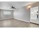Bright living room featuring wood floors, a modern ceiling fan, and kitchen access at 1906 Palora Ave, Las Vegas, NV 89169