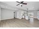 Open living area featuring a kitchen island, modern appliances, and seamless connectivity with modern flooring at 1906 Palora Ave, Las Vegas, NV 89169
