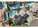 Aerial view of a home showcasing a pool, a tennis court, and lush landscaping at 1912 Calanda Ct, Las Vegas, NV 89102
