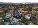 Aerial view of backyard amenities including pool, tennis court and well landscaped greenery at 1912 Calanda Ct, Las Vegas, NV 89102
