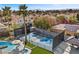 Aerial view highlighting a tennis court, swimming pool, and outdoor amenities in the backyard at 1912 Calanda Ct, Las Vegas, NV 89102