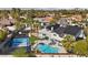 This stunning aerial view shows a backyard oasis with pool and tennis court amidst lush landscaping at 1912 Calanda Ct, Las Vegas, NV 89102