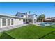 Well maintained backyard featuring a patio area, outdoor seating, a pool, and manicured lawn at 1912 Calanda Ct, Las Vegas, NV 89102