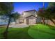 Manicured backyard features putting green and access to the patio at 1912 Calanda Ct, Las Vegas, NV 89102