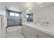 Modern bathroom with double sinks, stylish blue tiling, and a well-lit vanity mirror at 1912 Calanda Ct, Las Vegas, NV 89102