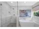 Bright bathroom features a glass shower, soaking tub, and white marble accents at 1912 Calanda Ct, Las Vegas, NV 89102