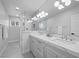 Modern bathroom with double vanity, large mirror, and glass-enclosed shower at 1912 Calanda Ct, Las Vegas, NV 89102