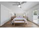 Comfortable bedroom with queen size bed, bright white walls, ceiling fan, and closet storage at 1912 Calanda Ct, Las Vegas, NV 89102