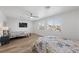 Spacious bedroom with two beds, ceiling fan and neutral decor with wood floors and a large window at 1912 Calanda Ct, Las Vegas, NV 89102