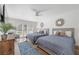 Inviting bedroom featuring two twin beds, a ceiling fan, and access to outdoor views at 1912 Calanda Ct, Las Vegas, NV 89102