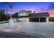 Exterior of a two-story home with an expansive driveway and a three-car garage at 1912 Calanda Ct, Las Vegas, NV 89102