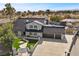 A gorgeous two-story home featuring a three-car garage and perfectly manicured front yard and walkway at 1912 Calanda Ct, Las Vegas, NV 89102