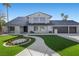Charming home with a beautifully landscaped front yard, sidewalk, and three-car garage at 1912 Calanda Ct, Las Vegas, NV 89102