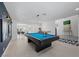 An interior angle showcases the game room with a pool table, accented with a navy wall and modern light fixtures at 1912 Calanda Ct, Las Vegas, NV 89102