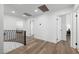 Open hallway with wood floors, black railings, and white walls, creating a bright and spacious feel at 1912 Calanda Ct, Las Vegas, NV 89102