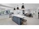 Open concept kitchen featuring a large island with seating, stainless appliances, and seamlessly flows into the living room at 1912 Calanda Ct, Las Vegas, NV 89102