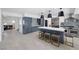 A large kitchen with an island and bar seating, adjacent to the dining area with stainless steel appliances at 1912 Calanda Ct, Las Vegas, NV 89102