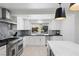A modern kitchen is enhanced with stainless steel appliances, light-colored cabinets, and backyard views at 1912 Calanda Ct, Las Vegas, NV 89102