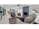Bright living room with tiled fireplace and open floor plan leading to kitchen and dining area at 1912 Calanda Ct, Las Vegas, NV 89102