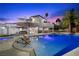 Stunning backyard pool area with ample seating and beautiful landscaping at 1912 Calanda Ct, Las Vegas, NV 89102
