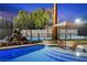 Backyard pool with a rock waterfall feature, poolside lounge chairs and a pickleball court at 1912 Calanda Ct, Las Vegas, NV 89102