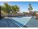 Well-maintained tennis court with surrounding mature trees and greenery at 1912 Calanda Ct, Las Vegas, NV 89102