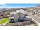 This backyard offers a relaxing outdoor seating area, an artificial lawn area, and a retaining wall at 2604 Iron Crest Ln, Las Vegas, NV 89138