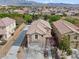 Two-story home in a residential neighborhood with a desert landscape and mountain views at 2624 Courlan Dr, North Las Vegas, NV 89084