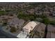 Aerial view of home and neighborhood featuring desert landscape and nearby city at 2624 Courlan Dr, North Las Vegas, NV 89084