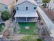 An aerial view of a backyard with artificial turf, covered patio, and cozy fire pit, fenced for privacy at 2624 Courlan Dr, North Las Vegas, NV 89084