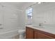 Bathroom featuring a tub and shower combo, single vanity, and window at 2624 Courlan Dr, North Las Vegas, NV 89084