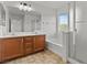 Bathroom featuring double sinks, soaking tub, and glass shower at 2624 Courlan Dr, North Las Vegas, NV 89084