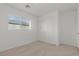 Carpeted bedroom with a large window and sliding closet doors at 2624 Courlan Dr, North Las Vegas, NV 89084