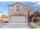 Two-story home featuring a two-car garage, desert landscaping and a well-maintained front yard at 2624 Courlan Dr, North Las Vegas, NV 89084
