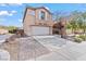 Two-story home featuring a two-car garage and low-maintenance desert landscaping at 2624 Courlan Dr, North Las Vegas, NV 89084