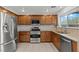 Well-lit kitchen featuring stainless steel appliances, granite countertops, and abundant cabinet storage at 2624 Courlan Dr, North Las Vegas, NV 89084