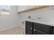 Laundry room featuring a utility sink and upper shelving at 2624 Courlan Dr, North Las Vegas, NV 89084