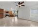 Open-concept living room with a view of the kitchen and a ceiling fan at 2624 Courlan Dr, North Las Vegas, NV 89084