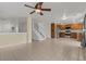 Open-concept living area with stairs, tile flooring and a view of kitchen at 2624 Courlan Dr, North Las Vegas, NV 89084