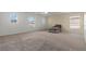 Spacious living room featuring plush carpeting, a ceiling fan, and lots of natural light throughout at 2624 Courlan Dr, North Las Vegas, NV 89084