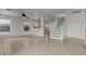 Open floor plan with neutral tile flooring, a ceiling fan, and natural light throughout the living space at 2624 Courlan Dr, North Las Vegas, NV 89084