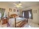 Spacious bedroom featuring a four-poster bed, ceiling fan and tile floors at 2735 Poppyseed Way, Las Vegas, NV 89142