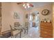 Cozy dining area with a glass-top table, adjacent to the kitchen, and lots of natural light at 2735 Poppyseed Way, Las Vegas, NV 89142