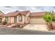 Street view of a single-story home featuring a red tile roof and a two car garage with mature landscaping at 2735 Poppyseed Way, Las Vegas, NV 89142