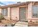 Close-up of the front entrance, featuring a security door, house number, and mature landscaping in the front yard at 2735 Poppyseed Way, Las Vegas, NV 89142